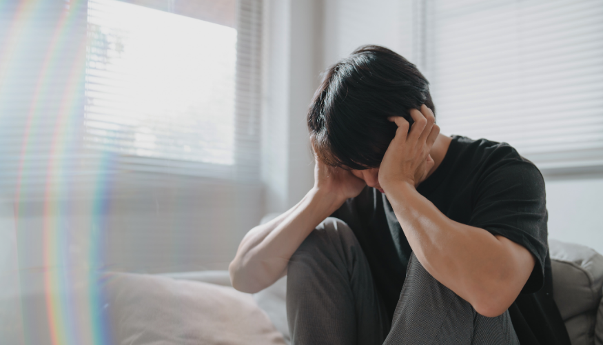 Man feeling anxious with head in hands