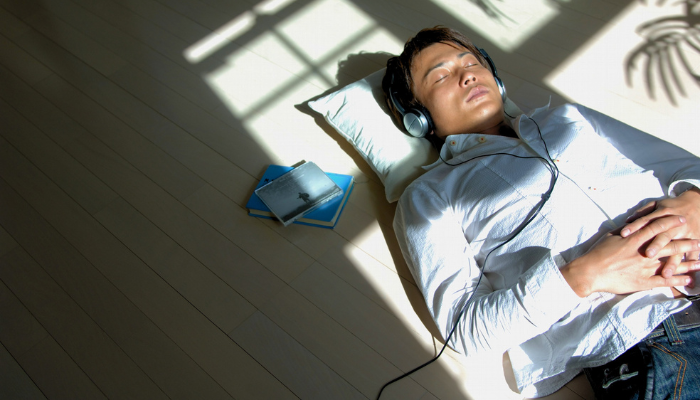 Person relaxing with headphones showing CBD and Ashwagandha benefits