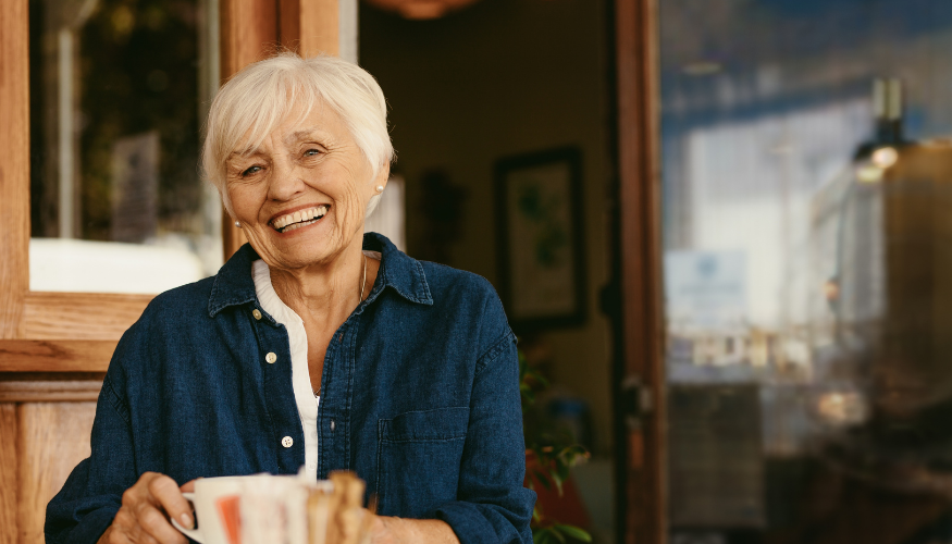 Smiling older woman enjoying coffee 